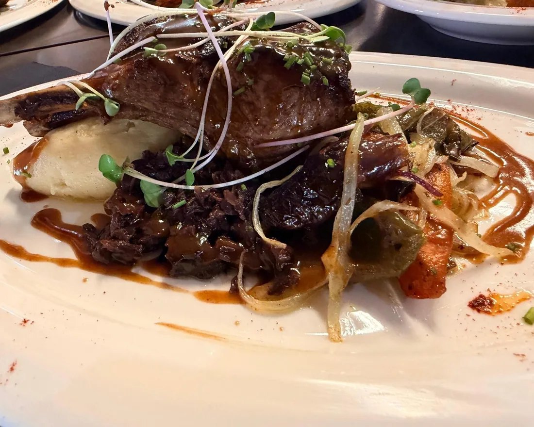 Slow-braised beef cheek on mash with vegetables and a glossy sauce